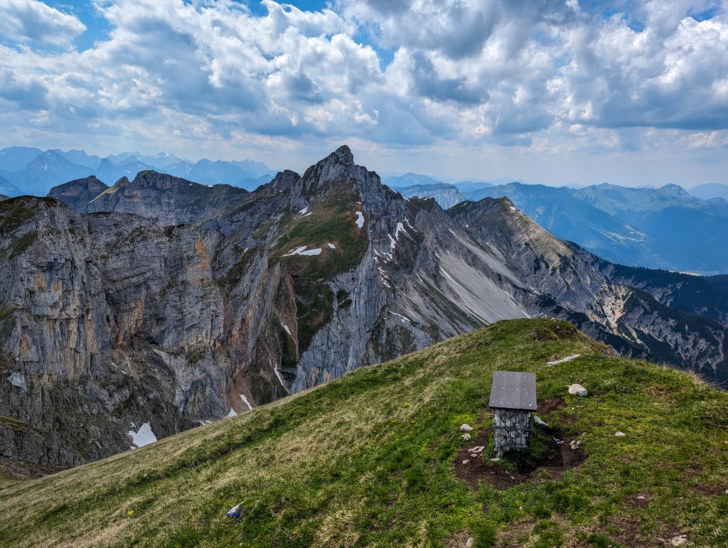 Well placed resting bench on Seekarlspitze and Hochiss cliff in the background