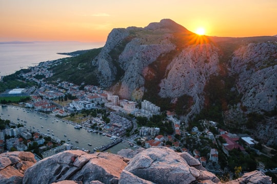 Sunset on top of the Fortica with Omiš and Cetina river and sea coastline in the background